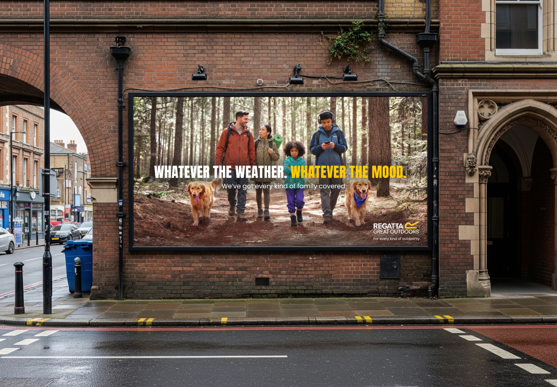 Regatta campaign billboard — family on a forest trail. Whatever the weather. Whatever the mood.